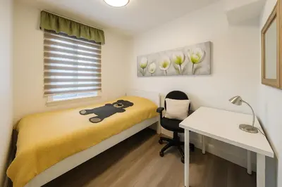 a bedroom with a bed and a desk and a table at Grand Appartement 4 Chambres Rénové et Meublé in Montréal