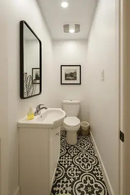 a white bathroom with a sink and a toilet at Grand Appartement 4 Chambres Rénové et Meublé in Montréal