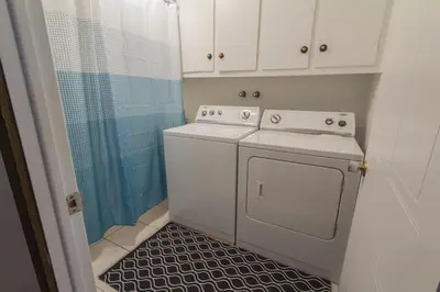 a kitchen with a washing machine and a shower at Piece of heaven near Montreal in Saint-Marc-sur-Richelieu