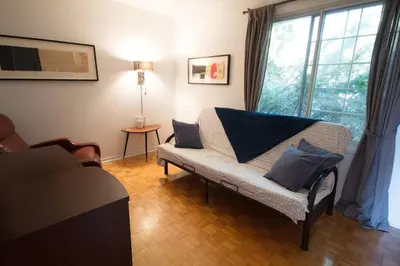 a living room with a couch and a large window at Piece of heaven near Montreal in Saint-Marc-sur-Richelieu