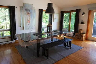 a dining room with a glass table and a bench at Piece of heaven near Montreal in Saint-Marc-sur-Richelieu