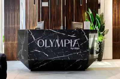 a black marble reception desk in a lobby at Olympia Hotel by Lodgo in Montréal