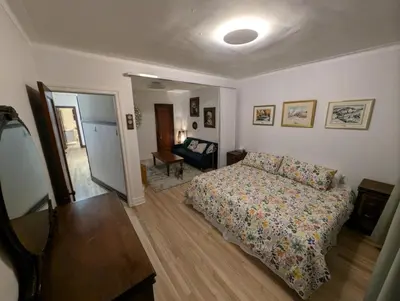 a bedroom with a bed and a living room at Appartement cosy au mois proche du Stade Olympique in Montréal