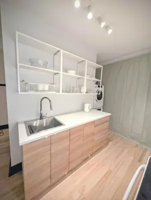 a kitchen with a sink and wooden cabinets at Appartement cosy au mois proche du Stade Olympique in Montréal