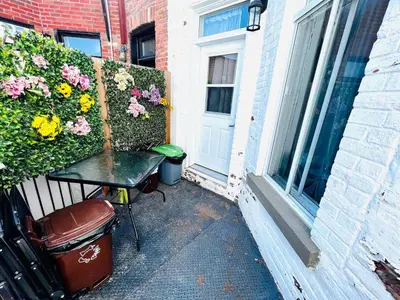 a patio with a table and flowers next to a door at Homa 1 in Montréal