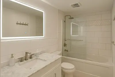 a bathroom with a sink and a toilet and a shower at Chic 3BR Stay in Laval, Bright and Peaceful in Laval