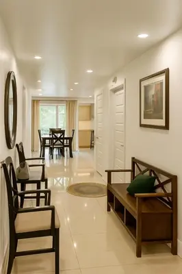 a living room with chairs and a table at Chic 3BR Stay in Laval, Bright and Peaceful in Laval