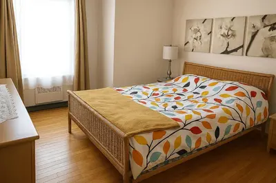 a bedroom with a bed with a colorful comforter at Sunny & Peaceful 1BR, Walk to UdM, HEC & Hospital in Montréal