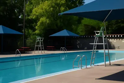 a swimming pool with blue umbrellas and tables and chairs at Sunny & Peaceful 1BR, Walk to UdM, HEC & Hospital in Montréal