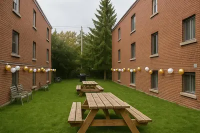 two picnic tables in a courtyard between two buildings at Bright Renovated 4BR, Heart of Côte-des-Neiges, Montreal in Montréal