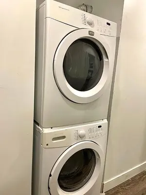 a dryer and a washing machine are next to each other at Bright Renovated 4BR, Heart of Côte-des-Neiges, Montreal in Montréal