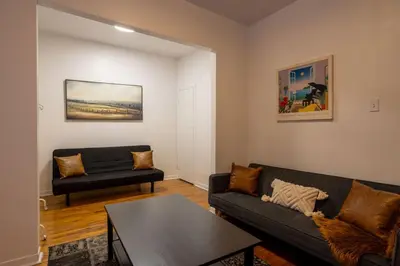 a living room with a couch and a table at Central 3BR downtown MTL Plateau Mont Royal in Montréal