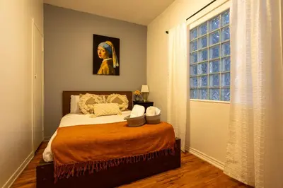 a bedroom with a bed and a window at Central 3BR downtown MTL Plateau Mont Royal in Montréal