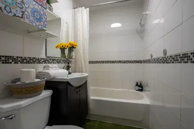 a bathroom with a sink and a tub and a toilet at Central 3BR downtown MTL Plateau Mont Royal in Montréal