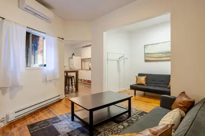 a living room with a couch and a table at Central 3BR downtown MTL Plateau Mont Royal in Montréal