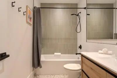 a bathroom with a tub and a toilet and a sink at Le Galeria, MTLVR in Montréal