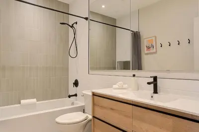 a bathroom with a sink and a toilet and a mirror at Le Galeria, MTLVR in Montréal