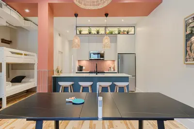 a kitchen and living room with a table and chairs at Le Galeria, MTLVR in Montréal