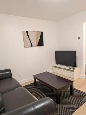 a living room with a couch and a coffee table at Stay close to Montreal in Longueuil