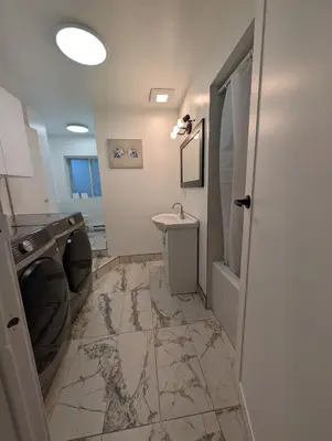 a bathroom with a sink and a toilet at Stay close to Montreal in Longueuil