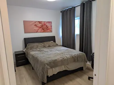 a bedroom with a bed and a window at Stay close to Montreal in Longueuil