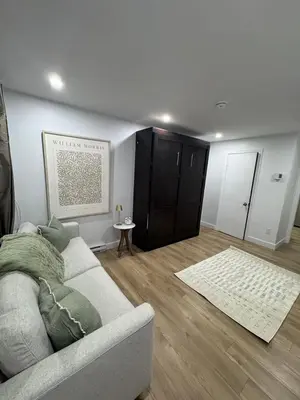 a living room with a couch and a rug at Casa Samson in Laval