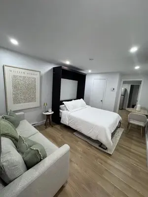 a bedroom with a bed and a couch in it at Casa Samson in Laval