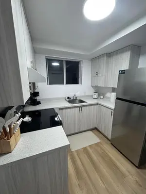 a kitchen with a stainless steel refrigerator and a window at Casa Samson in Laval
