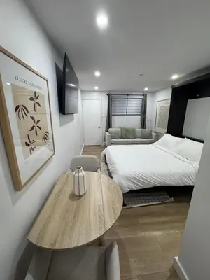 a bedroom with a bed and a table in a room at Casa Samson in Laval