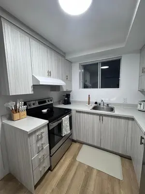 a kitchen with a sink and a stove at Casa Samson in Laval