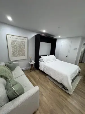 a bedroom with a bed and a couch at Casa Samson in Laval