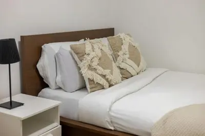 a bed with white sheets and pillows on it at Spectacular 2B unit in Montreal in Montréal