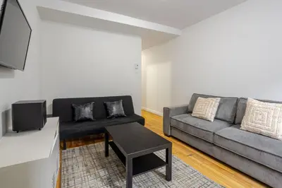 a living room with a couch and a table at Spectacular 2B unit in Montreal in Montréal
