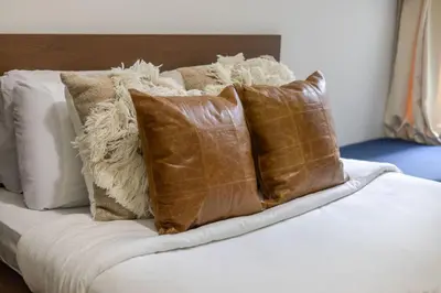 a bunch of pillows sitting on top of a bed at Spectacular 2B unit in Montreal in Montréal