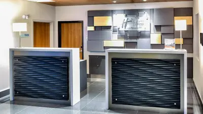 two metal garage doors in a room with a wall at Holiday Inn Express & Suites Vaudreuil-Dorion by IHG in Vaudreuil-Dorion