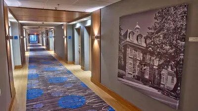 a hallway with a picture of a building on the wall at Holiday Inn Express & Suites Vaudreuil-Dorion by IHG in Vaudreuil-Dorion