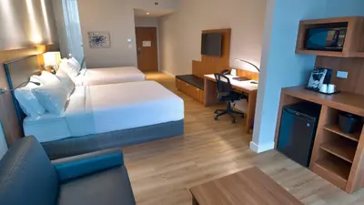 a hotel room with a bed and a desk at Holiday Inn Express & Suites Vaudreuil-Dorion by IHG in Vaudreuil-Dorion