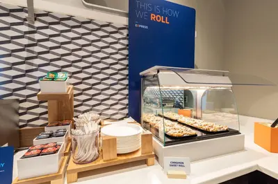 a display case with donuts and other pastries at Holiday Inn Express & Suites Vaudreuil-Dorion by IHG in Vaudreuil-Dorion