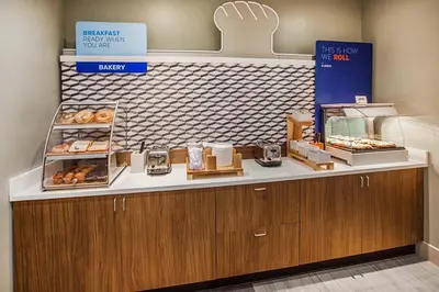 a bakery with a counter with donuts on it at Holiday Inn Express & Suites Vaudreuil-Dorion by IHG in Vaudreuil-Dorion