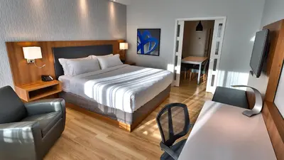 a hotel room with a bed and a couch at Holiday Inn Express & Suites Vaudreuil-Dorion by IHG in Vaudreuil-Dorion