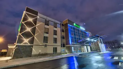 a building with blue lights on the side of it at Holiday Inn Express & Suites Vaudreuil-Dorion by IHG in Vaudreuil-Dorion