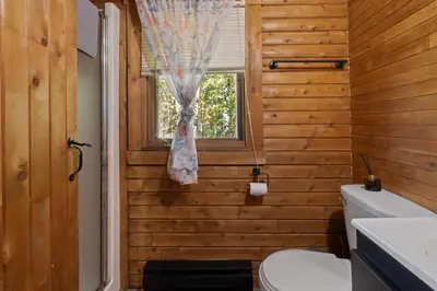 a bathroom with a toilet and a window at Chalet 1 cuisine - Domaine de l'Archipel in Sorel