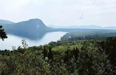 a view of a large body of water with mountains at Cozy Stay with Balcony, BBQ & Trails, Near Lake Lyster in Coaticook