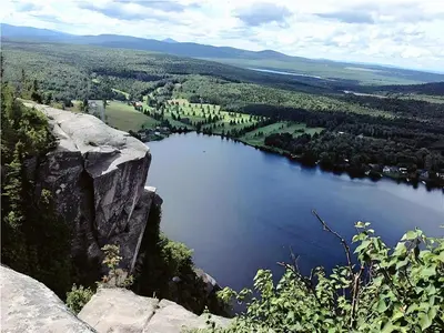 a view of a large lake from a mountain at Cozy Stay with Balcony, BBQ & Trails, Near Lake Lyster in Coaticook