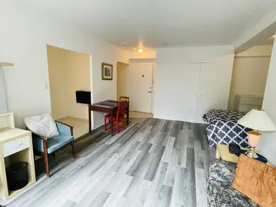 a room with a bed and a desk and a bed at Stylish Montreal Apartment Comfortable Stay in the Golden Square Mile in Montréal