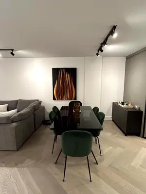 a living room with a glass table and a couch at Elegant Downtown Retreat with Balcony & Parking in Montréal