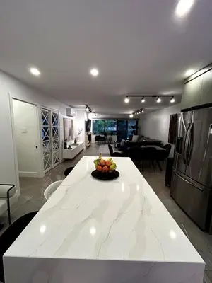 a kitchen with a table with a bowl of fruit on it at Elegant Downtown Retreat with Balcony & Parking in Montréal