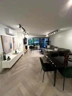 a large living room with a couch and a table at Elegant Downtown Retreat with Balcony & Parking in Montréal