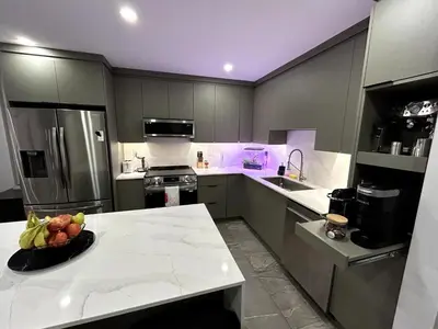 a kitchen with a bowl of fruit on a counter at Elegant Downtown Retreat with Balcony & Parking in Montréal