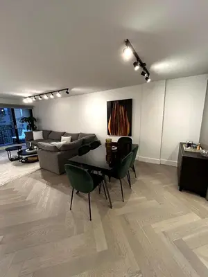 a living room with a table and a couch at Elegant Downtown Retreat with Balcony & Parking in Montréal